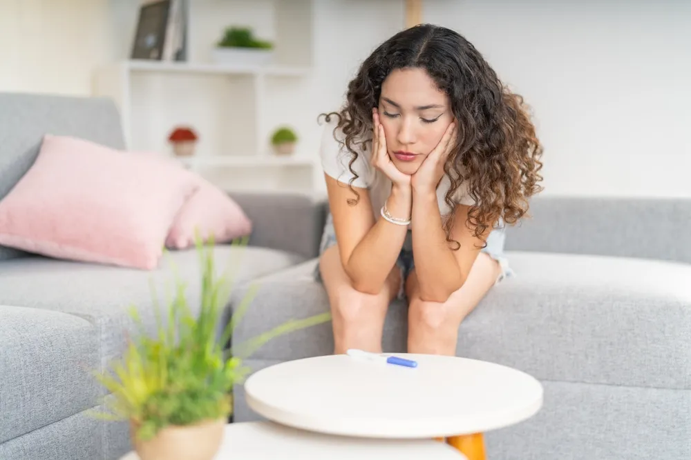 Concerned woman sitting on a couch