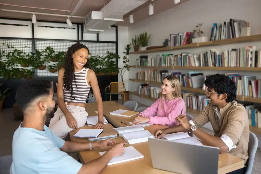 Group of friends smiling and laughing in a library setting