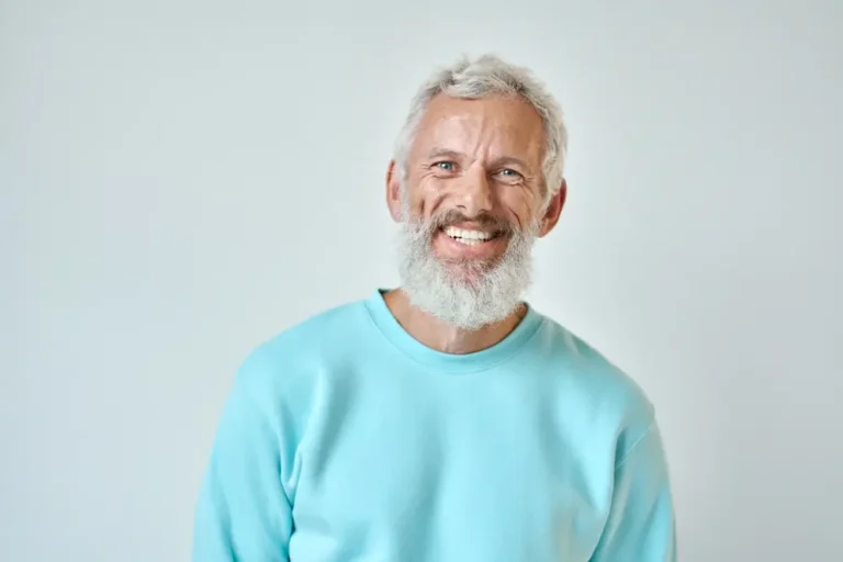 Happy mature old bearded man with dental smile