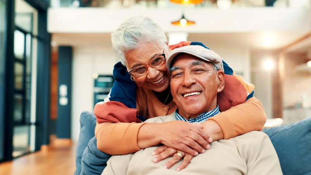 Happy older couple smiling in each other’s embrace