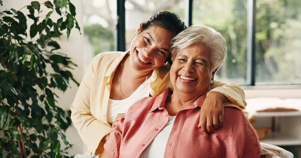 Mother and daughter smiling on couch