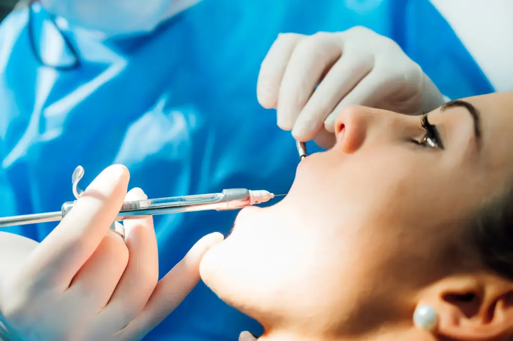 Oral Surgeon anesthetizing patient´s mouth during a procedure.